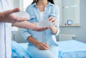 woman examining her breast implant options